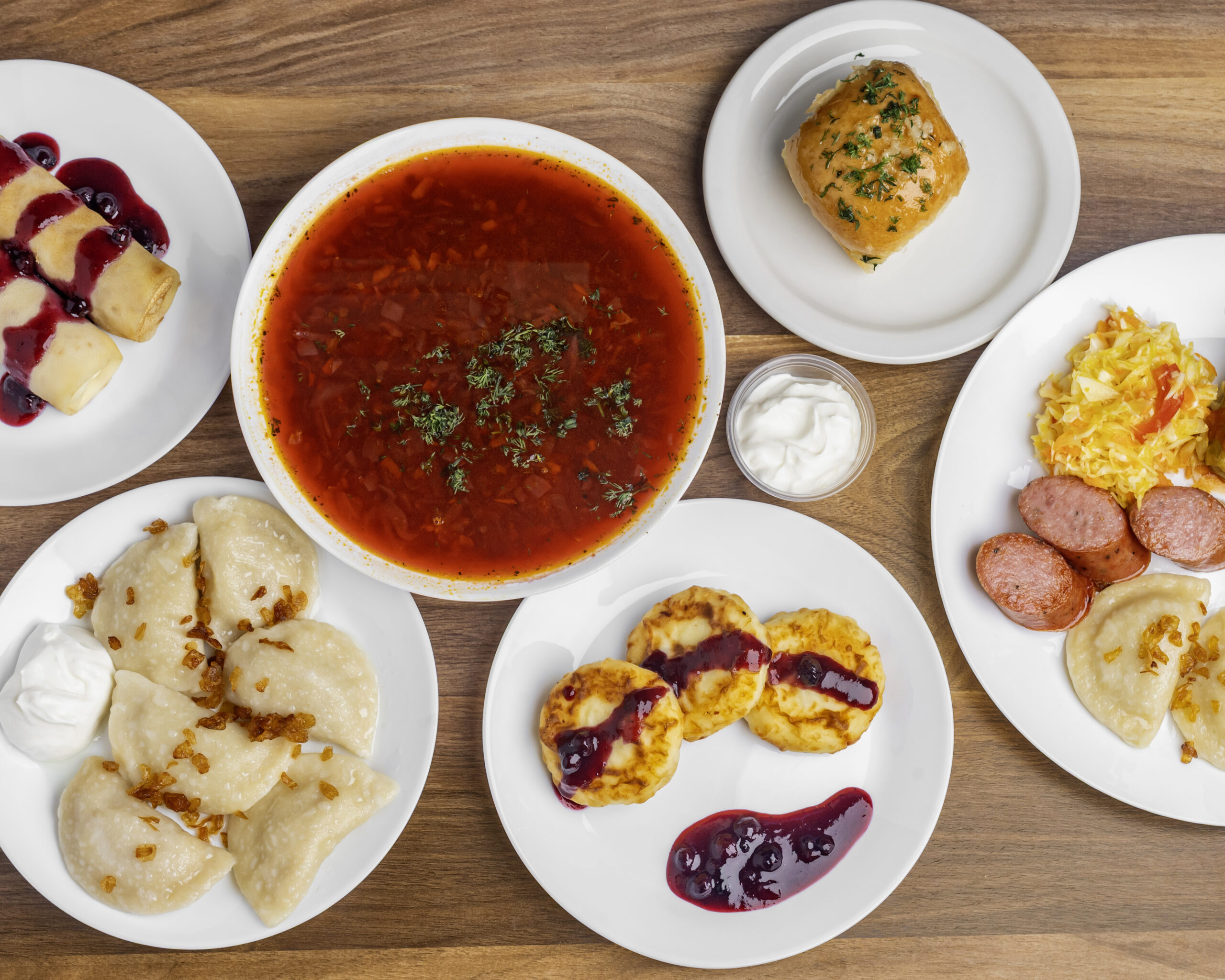 Spread of borshch, perogies, sausage and syrnyky